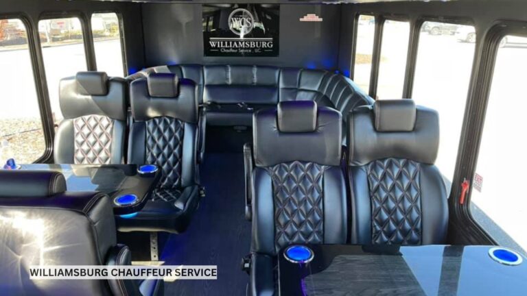 Luxury party bus interior with leather wraparound seating, LED accent lighting, and polished flooring in an empty cabin ready for guests.