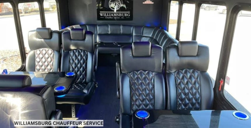Luxury party bus interior with leather wraparound seating, LED accent lighting, and polished flooring in an empty cabin ready for guests.
